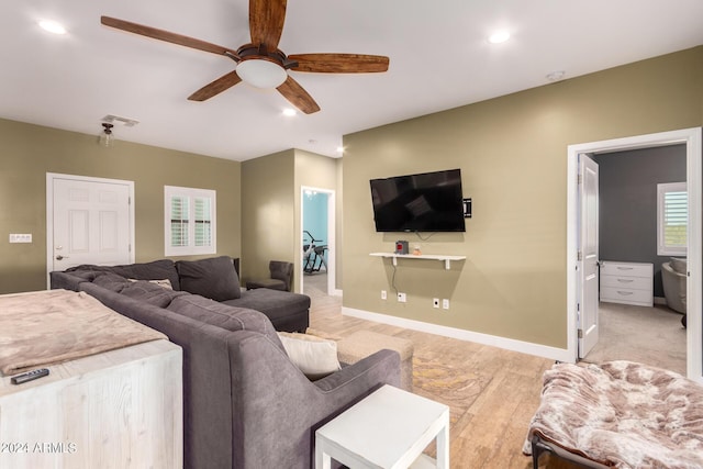 living room featuring ceiling fan and light wood-type flooring