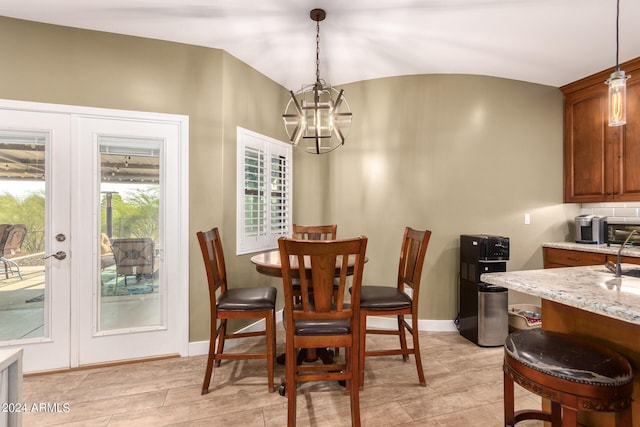 dining area featuring a chandelier, french doors, and light hardwood / wood-style floors