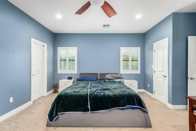 bedroom featuring light carpet and ceiling fan