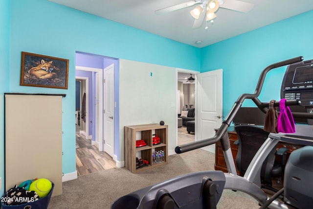 workout room with light carpet and ceiling fan