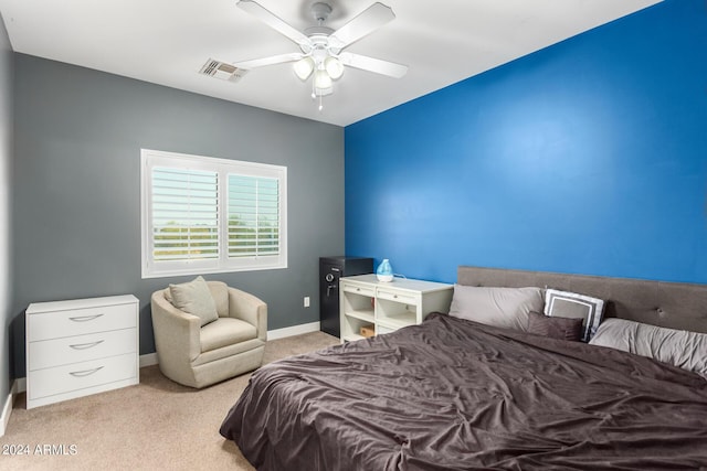 bedroom featuring light colored carpet and ceiling fan