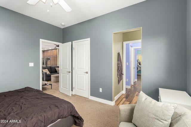 bedroom featuring light carpet and ceiling fan