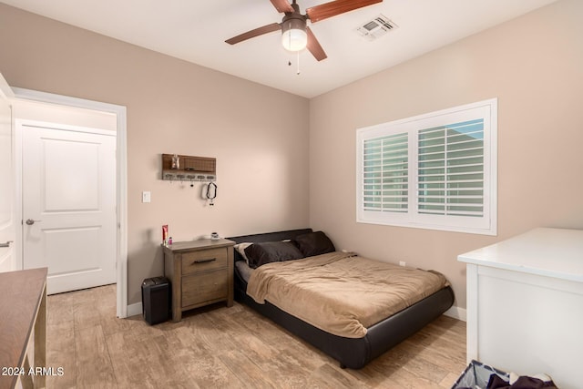 bedroom with light hardwood / wood-style flooring and ceiling fan