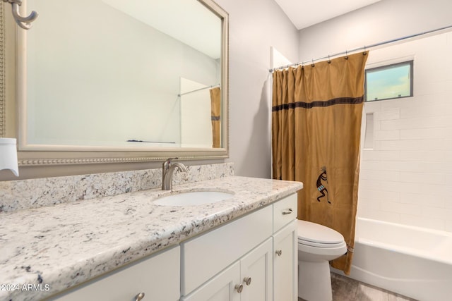 full bathroom with vanity, shower / bath combination with curtain, and toilet