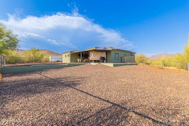 back of house with a mountain view