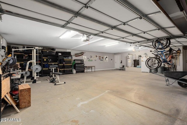 garage featuring water heater and a garage door opener