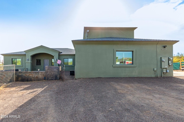 rear view of house featuring central AC