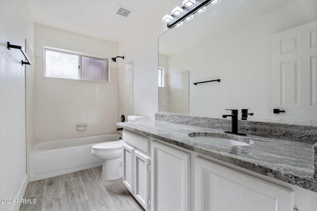 full bathroom featuring vanity, toilet, wood-type flooring, and bathtub / shower combination