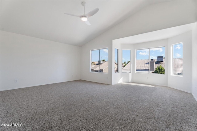 unfurnished living room with carpet flooring, high vaulted ceiling, and ceiling fan