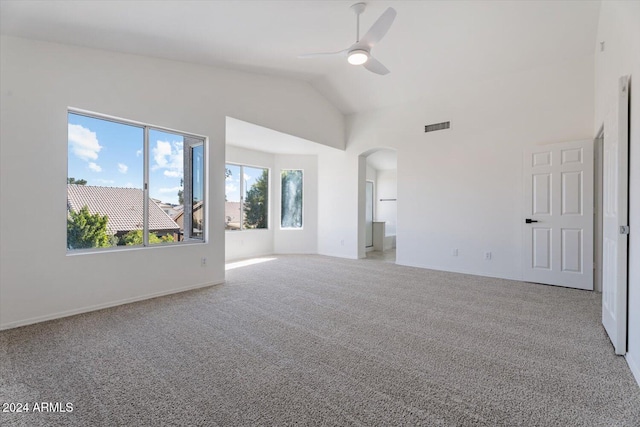 carpeted spare room featuring ceiling fan and lofted ceiling