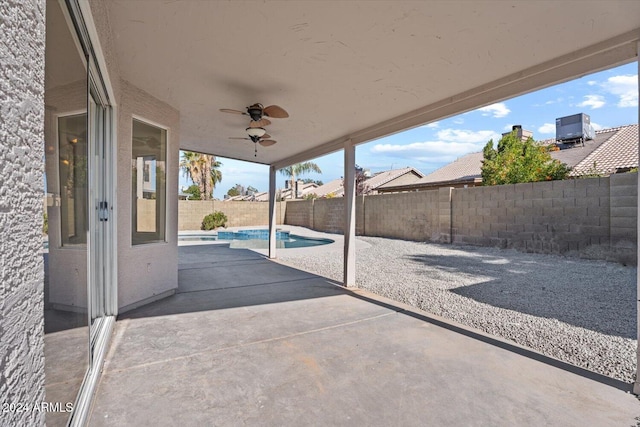 view of patio / terrace featuring a fenced in pool and ceiling fan