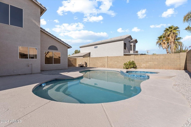 view of swimming pool with an in ground hot tub and a patio