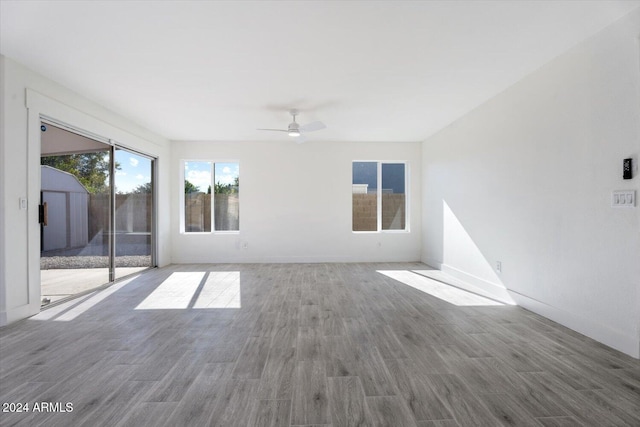 empty room with ceiling fan and wood-type flooring