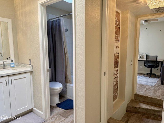 bathroom with vanity, hardwood / wood-style flooring, and toilet