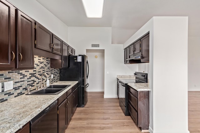 kitchen with dark brown cabinetry, dishwashing machine, black / electric stove, under cabinet range hood, and a sink