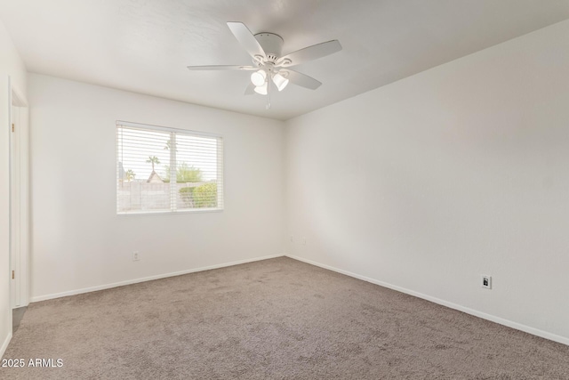 empty room featuring carpet floors, baseboards, and a ceiling fan