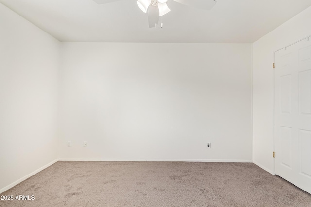 empty room featuring carpet, baseboards, and ceiling fan