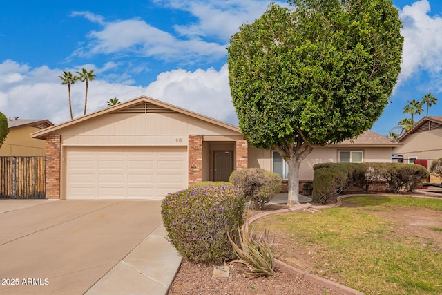 ranch-style home with a front yard, concrete driveway, brick siding, and an attached garage