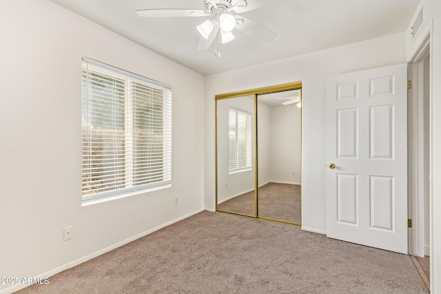 unfurnished bedroom featuring visible vents, baseboards, a ceiling fan, carpet flooring, and a closet