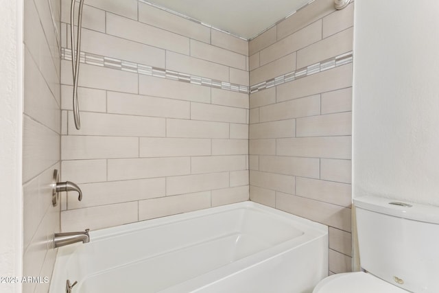 bathroom with toilet and bathing tub / shower combination