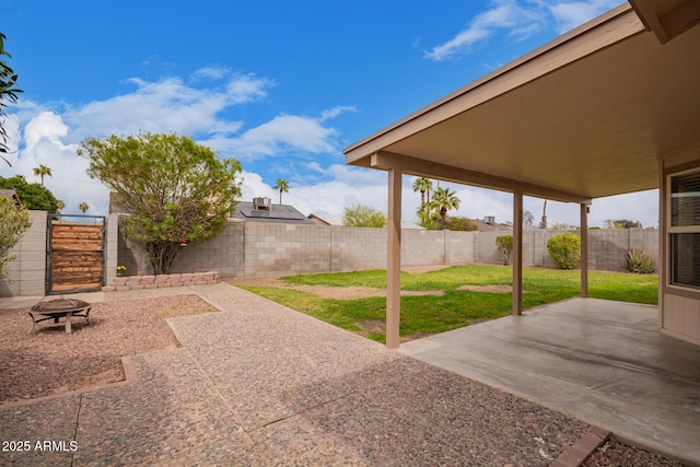 view of patio with a fenced backyard and a fire pit