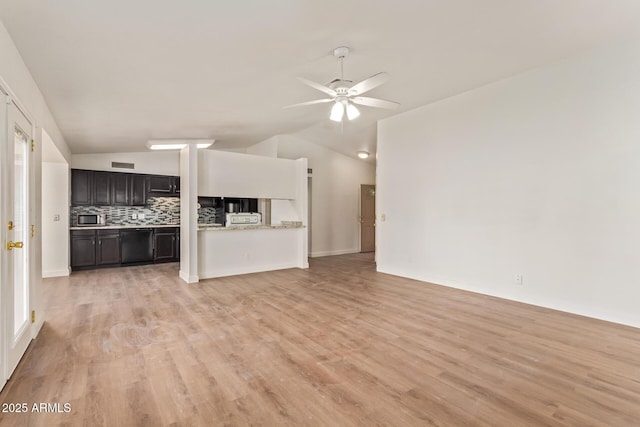 unfurnished living room with lofted ceiling, light wood-style floors, and a ceiling fan