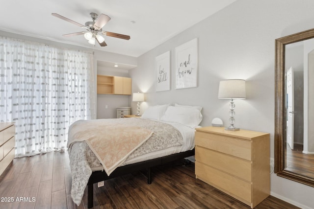 bedroom with baseboards, dark wood-type flooring, and a ceiling fan