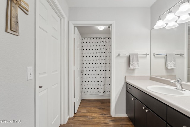 bathroom with wood finished floors and vanity