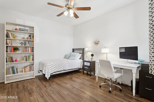 bedroom featuring ceiling fan, baseboards, and wood finished floors