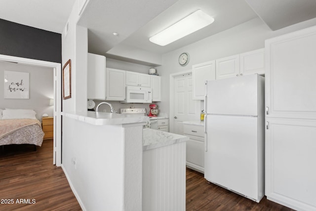 kitchen featuring white appliances, dark wood-style floors, a peninsula, light countertops, and white cabinets