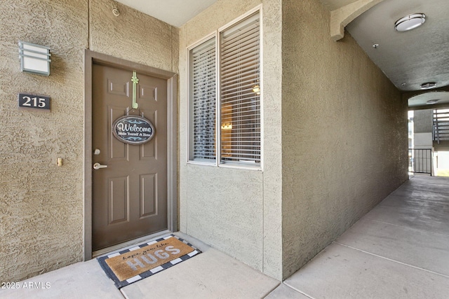 property entrance featuring stucco siding