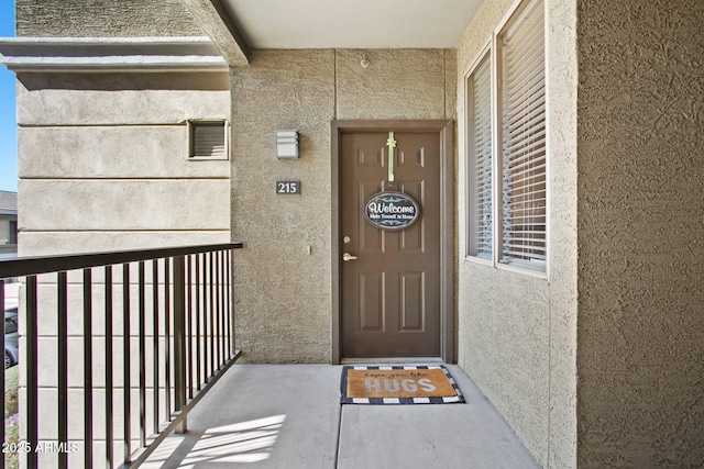 doorway to property with stucco siding