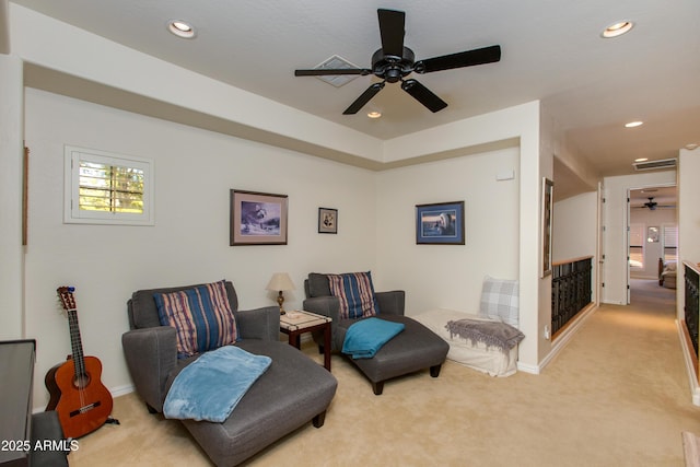 sitting room with ceiling fan and light carpet