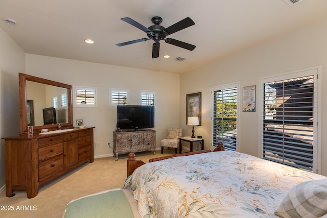 bedroom with ceiling fan, multiple windows, and light carpet