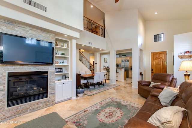 living room featuring a fireplace, built in features, and light tile patterned floors