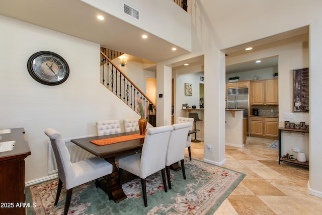 dining area with a high ceiling