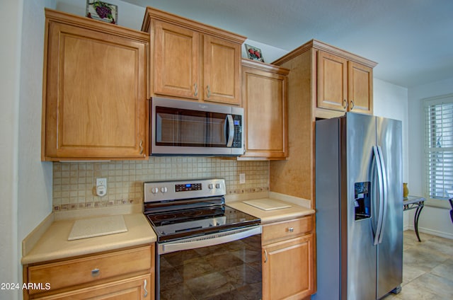 kitchen featuring stainless steel appliances and decorative backsplash