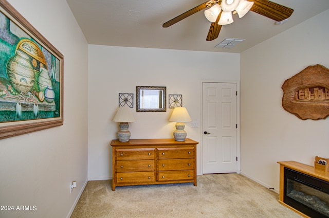 bedroom featuring light carpet and ceiling fan