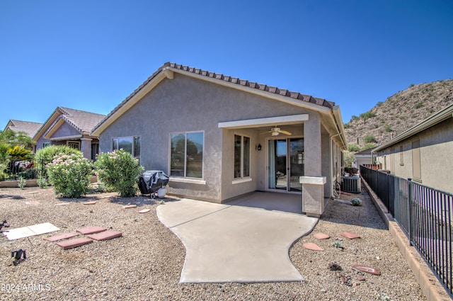 rear view of property featuring ceiling fan, central air condition unit, and a patio