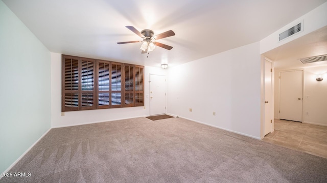 carpeted spare room featuring ceiling fan