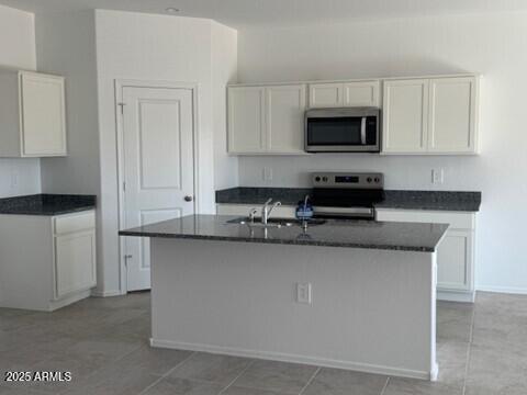 1336 W Hess Ave, Coolidge, AZ 85128 - kitchen featuring appliances with stainless steel finishes, white cabinets, and a sink