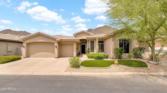 view of front of property with an attached garage, stucco siding, concrete driveway, a front lawn, and a tile roof