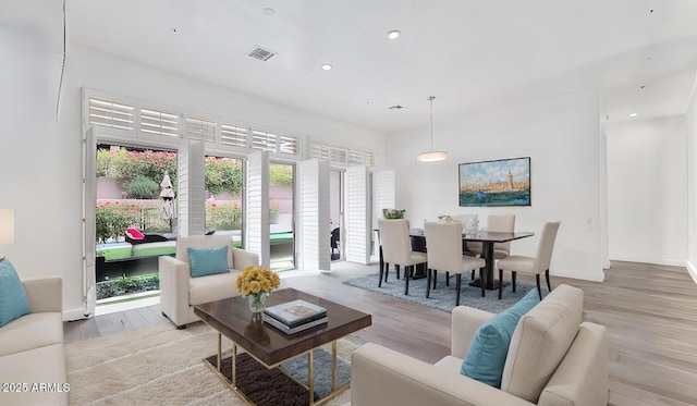 living area with recessed lighting and wood finished floors