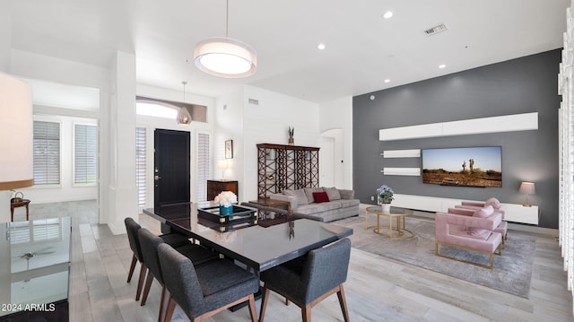 dining area featuring recessed lighting, visible vents, arched walkways, and wood finished floors