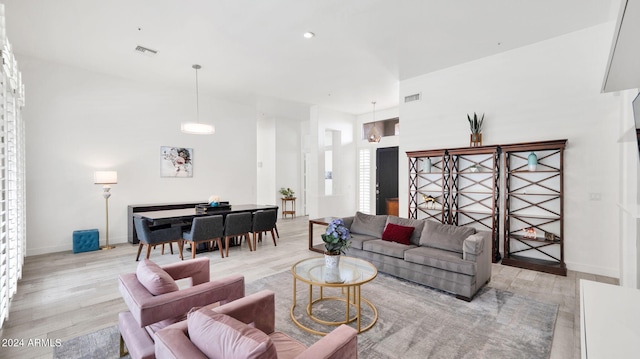 living area featuring recessed lighting, visible vents, baseboards, and light wood-style flooring