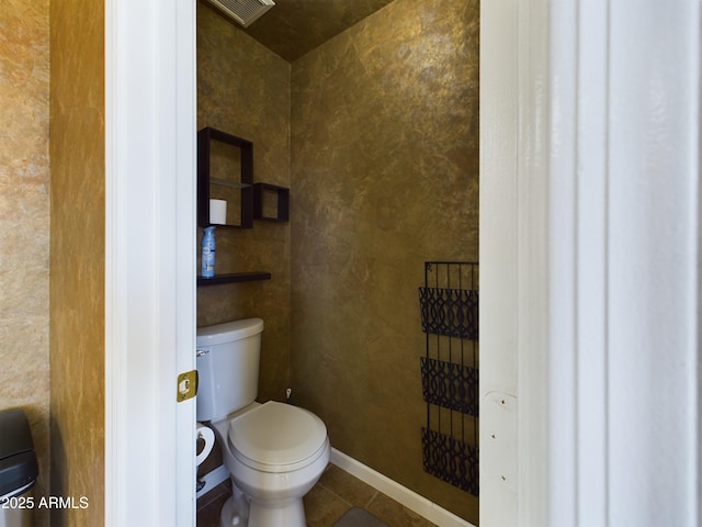 bathroom with tile patterned flooring, baseboards, visible vents, and toilet