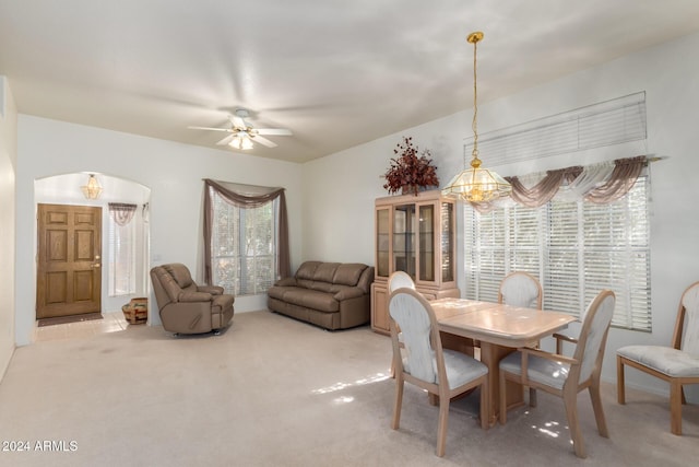 11553 W Sonoran Ct, Surprise, AZ 85378 - dining area featuring ceiling fan with notable chandelier, light colored carpet, and a wealth of natural light