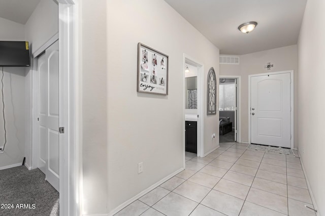 corridor with light tile patterned floors