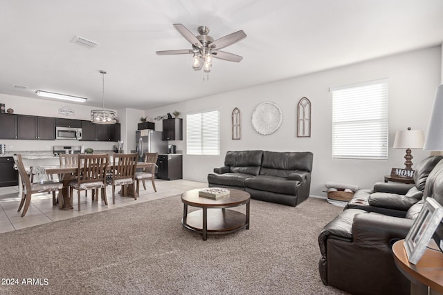 tiled living room featuring ceiling fan