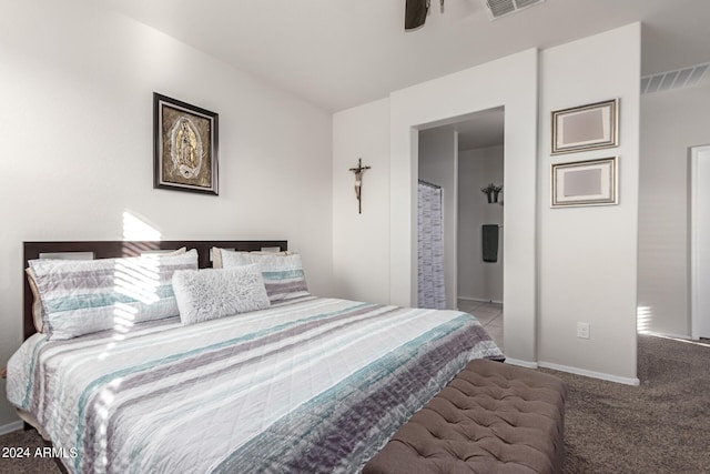 bedroom featuring connected bathroom, ceiling fan, and carpet floors